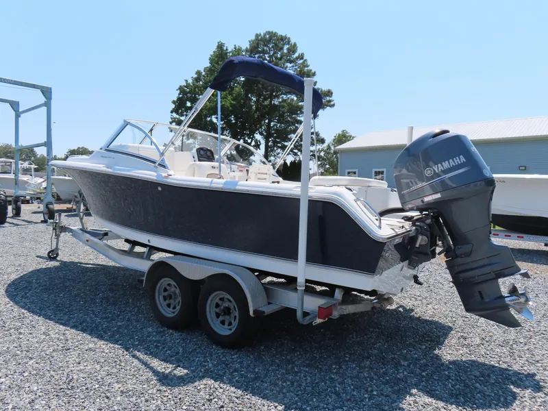 Slide: The Image of 2013 Sea Hunt Escape 211 LE boat on trailer with Yamaha outboard motor. - 1