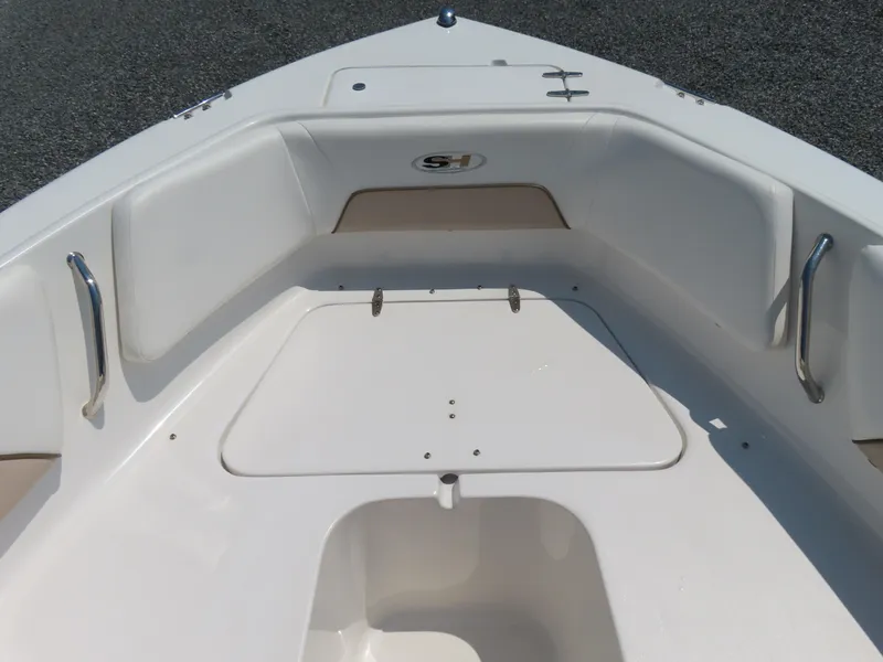 Slide: The Image of 2013 Sea Hunt Escape 211 LE boat interior with seating and storage. - 10