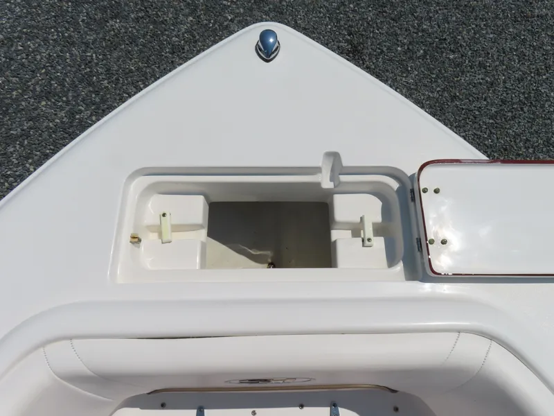 Slide: The Image of 2013 Sea Hunt Escape 211 LE boat bow storage compartment, open lid, white finish. - 13