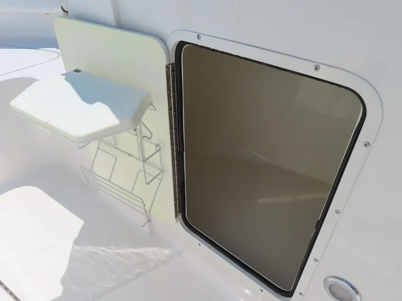 Slide: The Image of 2013 Sea Hunt Escape 211 LE boat storage compartment with open hatch. - 17
