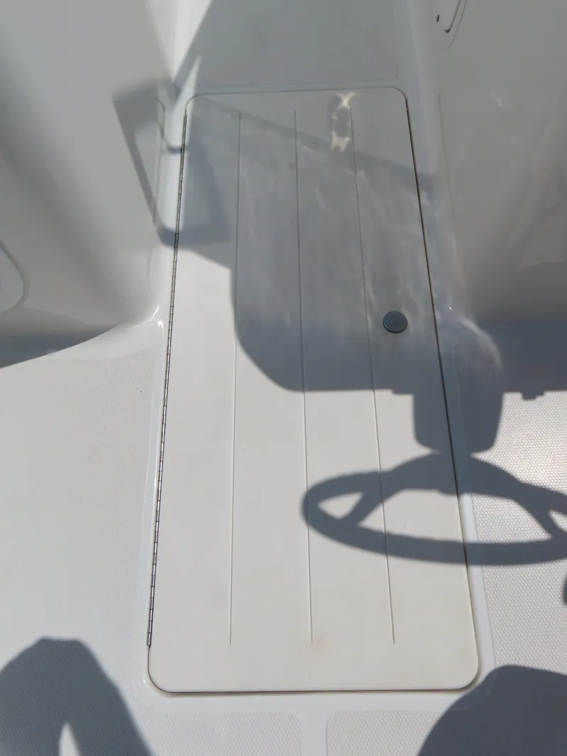 Slide: The Image of 2013 Sea Hunt Escape 211 LE boat deck with storage hatch. - 18