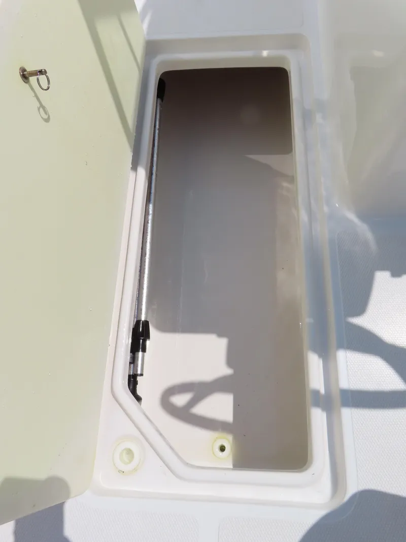 Slide: The Image of Storage compartment of 2013 Sea Hunt Escape 211 LE boat, open and empty. - 19