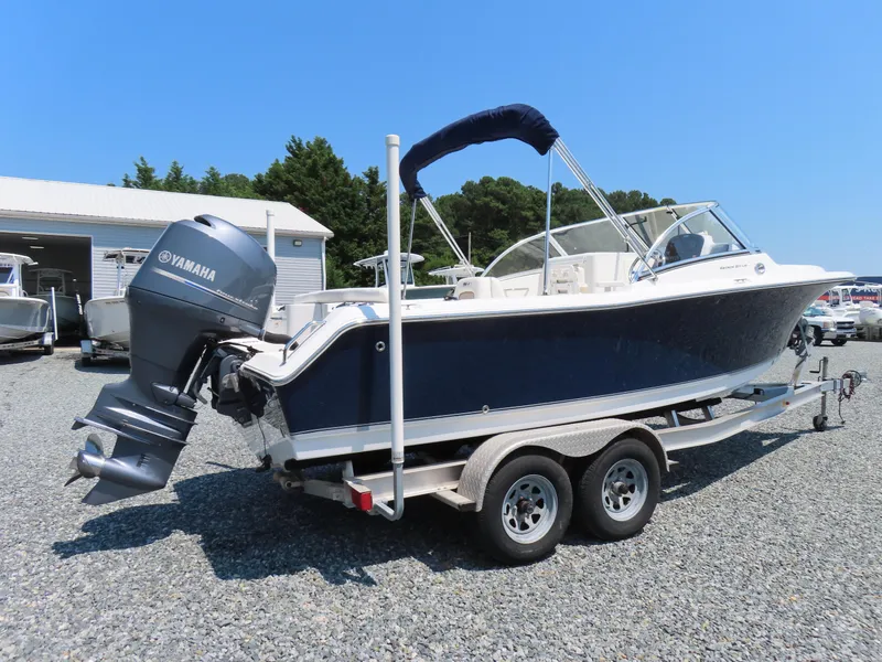 Slide: The Image of 2013 Sea Hunt Escape 211 LE boat on trailer with Yamaha outboard motor. - 2