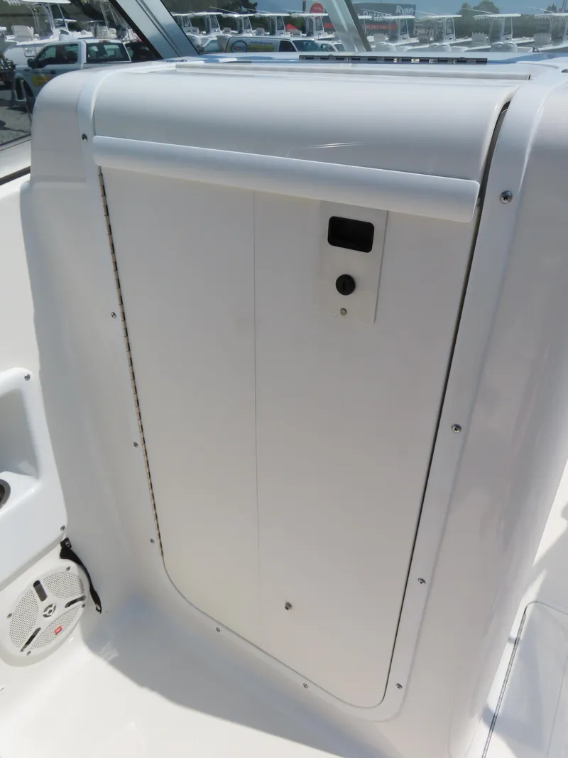 Slide: The Image of 2013 Sea Hunt Escape 211 LE boat interior detail with storage compartment. - 20