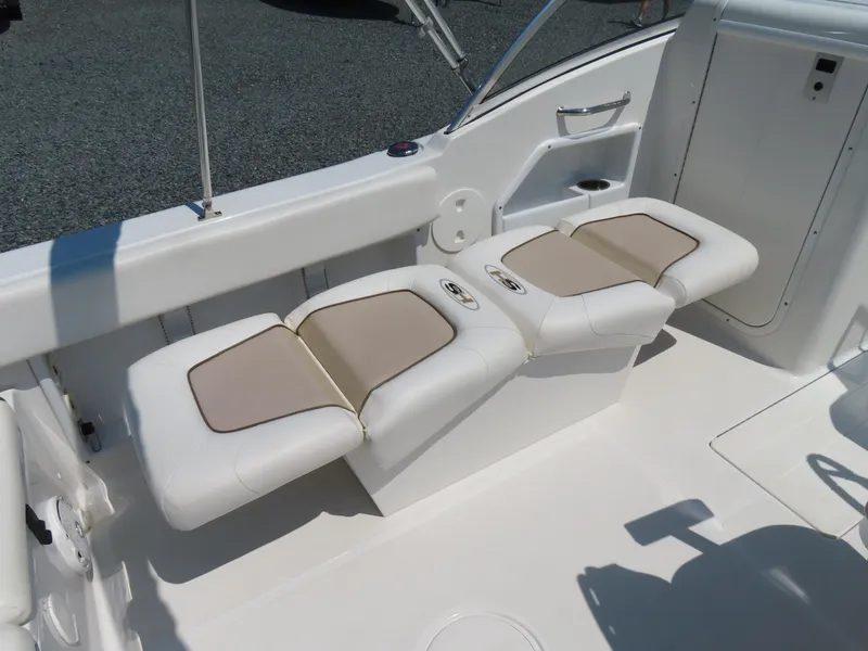 Slide: The Image of 2013 Sea Hunt Escape 211 LE boat interior with white and beige seating. - 23
