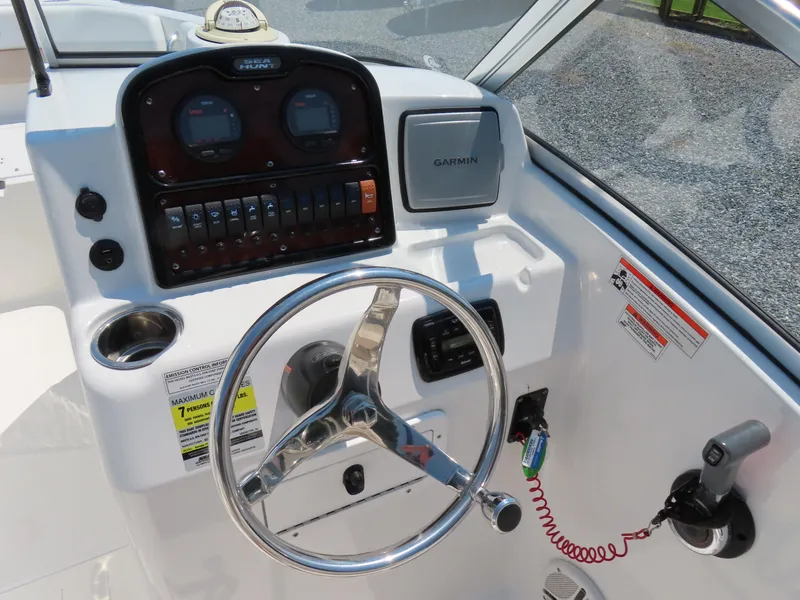 Slide: The Image of 2013 Sea Hunt Escape 211 LE boat dashboard with steering wheel and Garmin navigation system. - 25