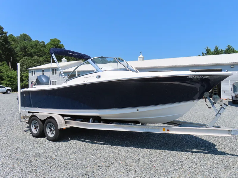 Slide: The Image of 2013 Sea Hunt Escape 211 LE boat on trailer, parked outdoors. - 3