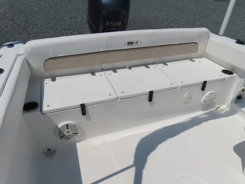 Slide: The Image of 2013 Sea Hunt Escape 211 LE boat interior with storage compartments and speakers. - 31