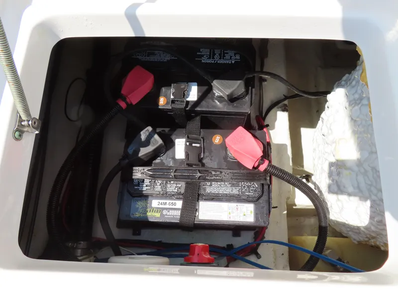 Slide: The Image of Battery compartment of 2013 Sea Hunt Escape 211 LE boat, showing dual batteries and wiring. - 33