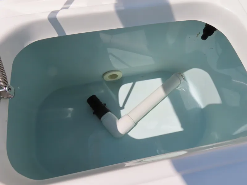Slide: The Image of Livewell tank in 2013 Sea Hunt Escape 211 LE boat, featuring plumbing and fittings. - 34