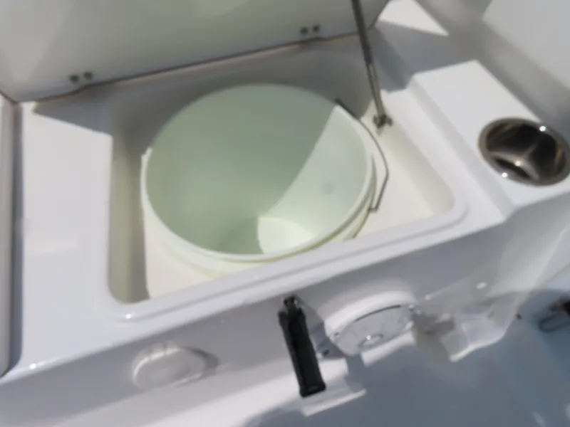 Slide: The Image of 2013 Sea Hunt Escape 211 LE boat storage compartment with bucket. - 35