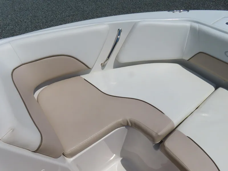 Slide: The Image of 2013 Sea Hunt Escape 211 LE boat seating area with beige and white cushions. - 8