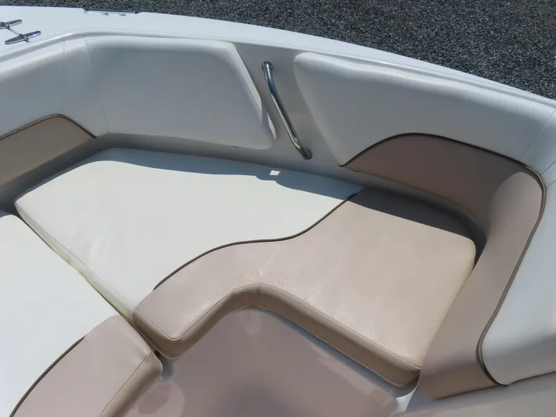 Slide: The Image of 2013 Sea Hunt Escape 211 LE boat interior seating with beige and white cushions. - 9