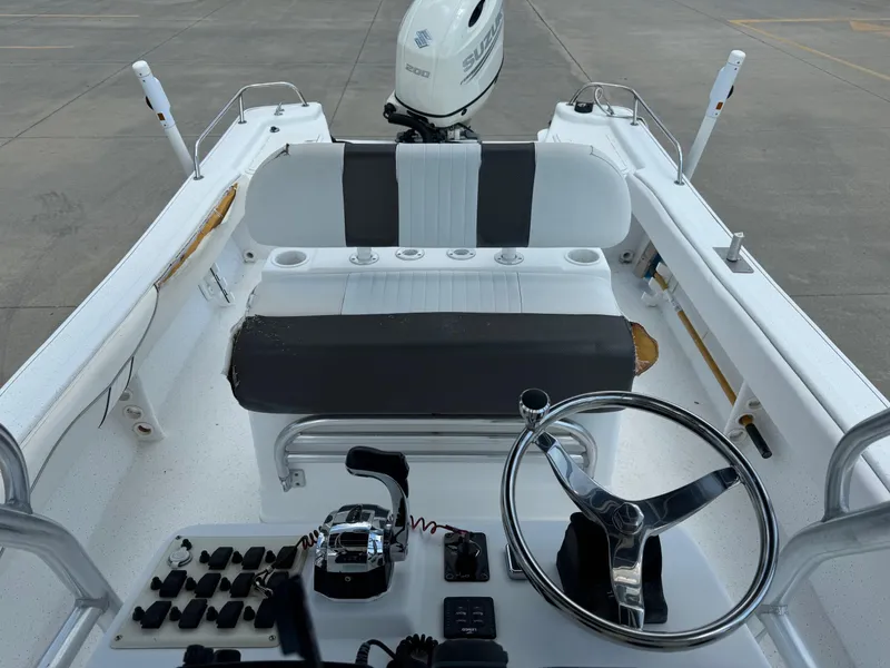 Slide: The Image of 2011 Carolina Skiff 25 Elite SS boat interior with steering wheel and controls. - 12