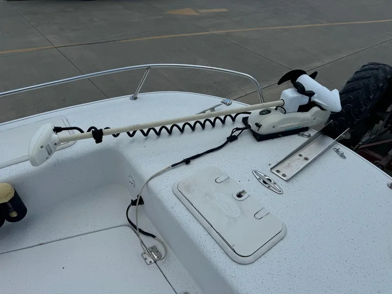 Slide: The Image of 2011 Carolina Skiff 25 Elite SS boat deck with trolling motor and storage hatch. - 14