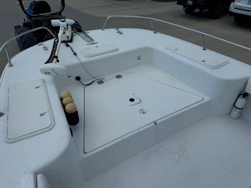 Slide: The Image of 2011 Carolina Skiff 25 Elite SS boat deck with storage compartments and railing. - 16