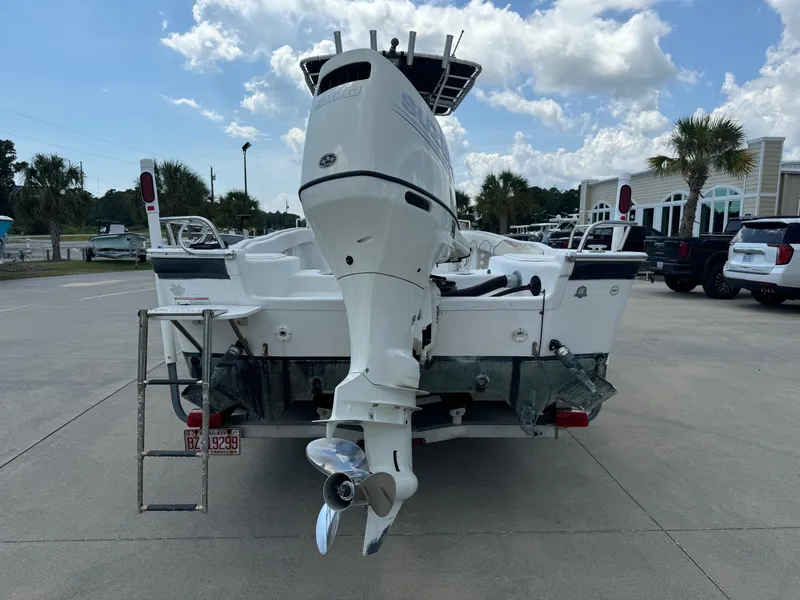 Slide: The Image of 2011 Carolina Skiff 25 Elite SS boat with outboard motor, parked outdoors. - 3