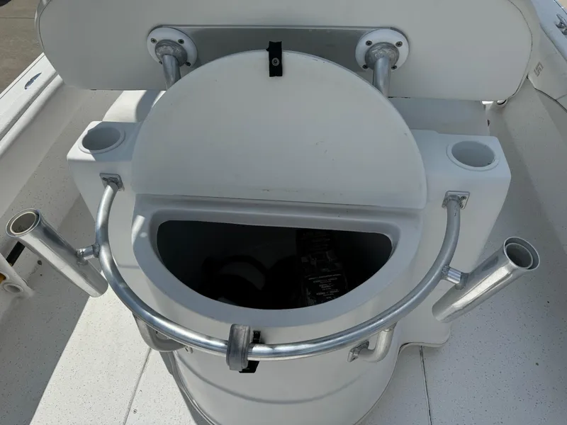 Slide: The Image of 2011 Carolina Skiff 25 Elite SS boat seat with rod holders and storage compartment. - 5