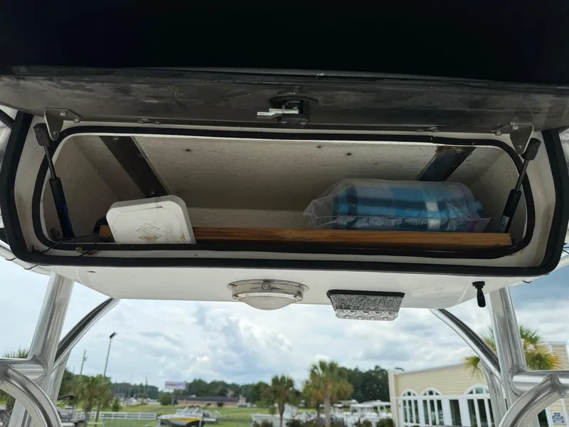 Slide: The Image of Storage compartment of a 2011 Carolina Skiff 25 Elite SS boat, containing various items. - 8