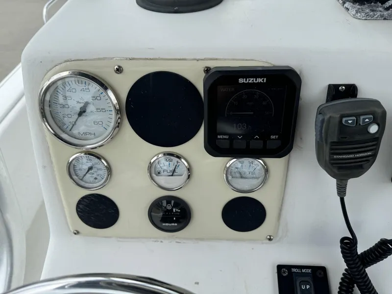 Slide: The Image of Control panel of a 2011 Carolina Skiff 25 Elite SS with gauges and radio. - 9