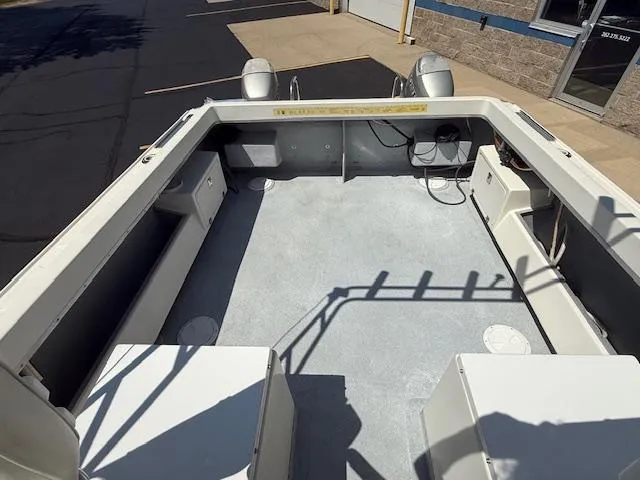 Slide: The Image of 1998 Kevlacat Series 2000 Cuddy Cabin OB boat interior with spacious deck and seating. - 10