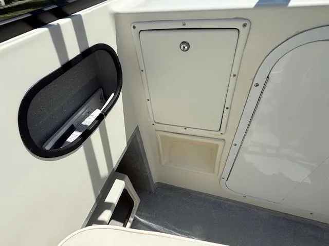 Slide: The Image of 1998 Kevlacat Series 2000 Cuddy Cabin OB interior, featuring storage compartments and sleek design. - 12