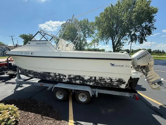 Slide: The Image of 1998 Kevlacat Series 2000 Cuddy Cabin OB on trailer, parked outdoors. - 3