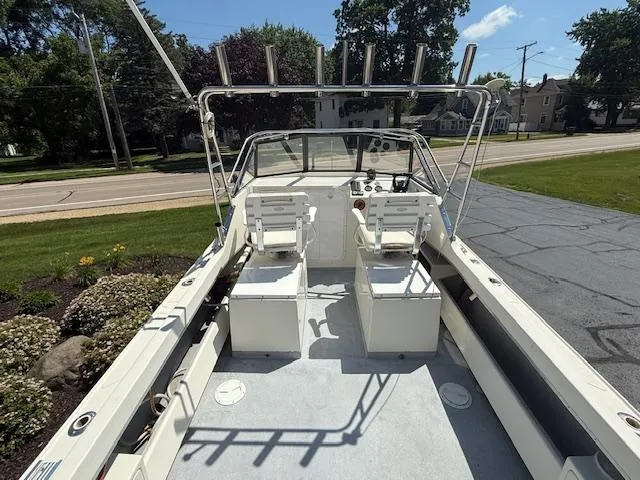 Slide: The Image of 1998 Kevlacat Series 2000 Cuddy Cabin OB boat interior with dual seats and rod holders. - 4