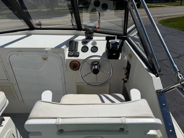 Slide: The Image of 1998 Kevlacat Series 2000 Cuddy Cabin OB helm with steering wheel and control panel. - 5