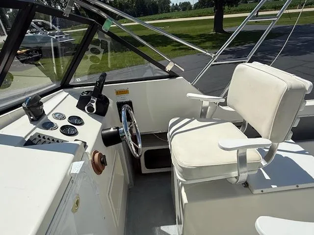 Slide: The Image of 1998 Kevlacat Series 2000 Cuddy Cabin OB interior with steering wheel and seating. - 6