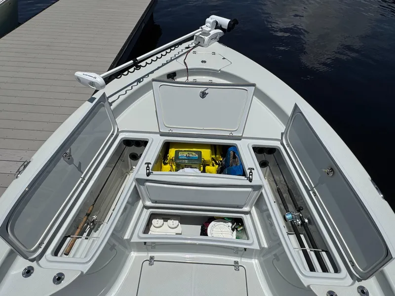 Slide: The Image of 2019 Blue Wave 2800 Pure Hybrid boat with open storage compartments and fishing gear. - 10