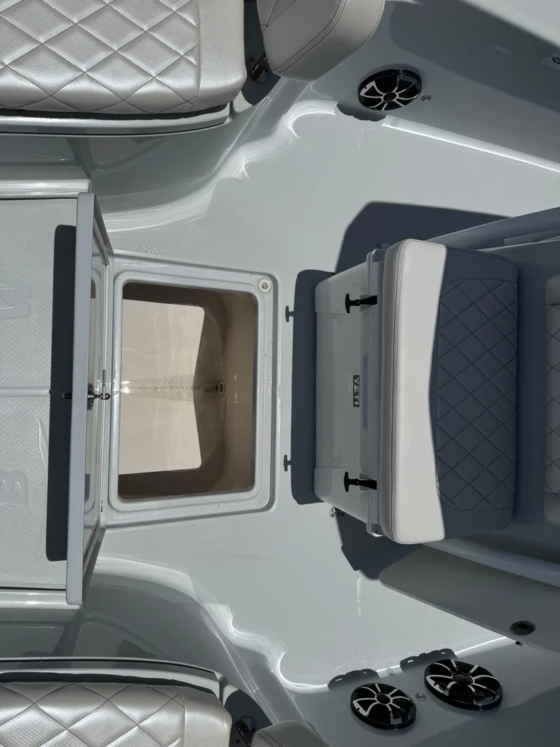 Slide: The Image of 2019 Blue Wave 2800 Pure Hybrid boat interior with open storage compartment and cushioned seating. - 11