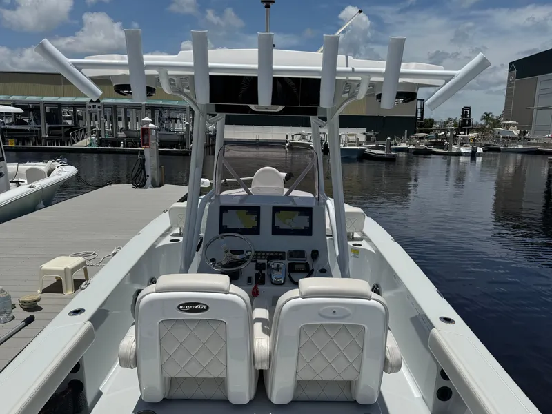 Slide: The Image of 2019 Blue Wave 2800 Pure Hybrid boat docked at marina under clear sky. - 12