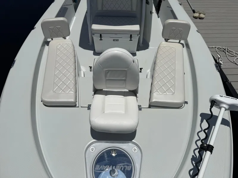 Slide: The Image of 2019 Blue Wave 2800 Pure Hybrid boat with white seating and Minn Kota trolling motor. - 13
