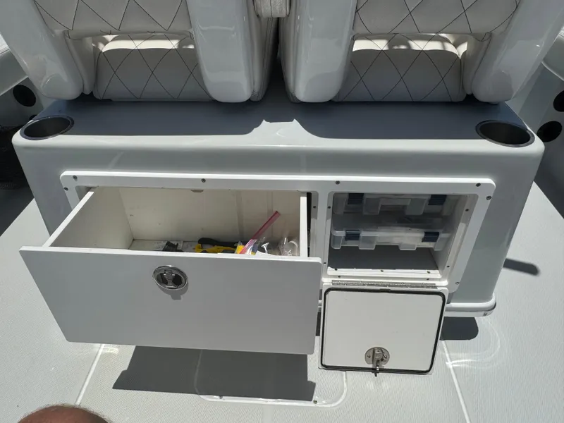 Slide: The Image of 2019 Blue Wave 2800 Pure Hybrid boat storage compartments with open drawers and seats. - 14