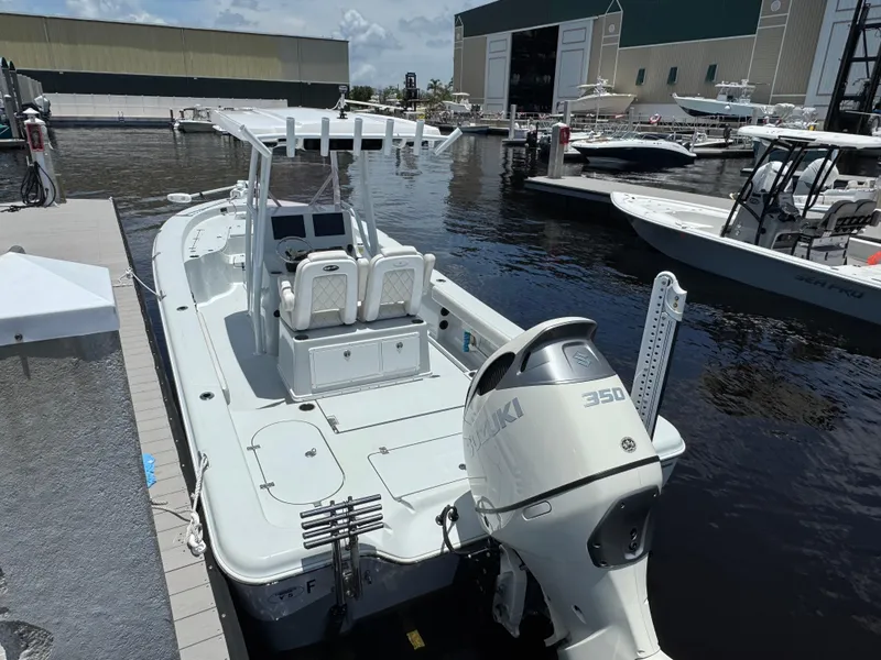 Slide: The Image of 2019 Blue Wave 2800 Pure Hybrid boat docked with Suzuki 350 engine. - 2