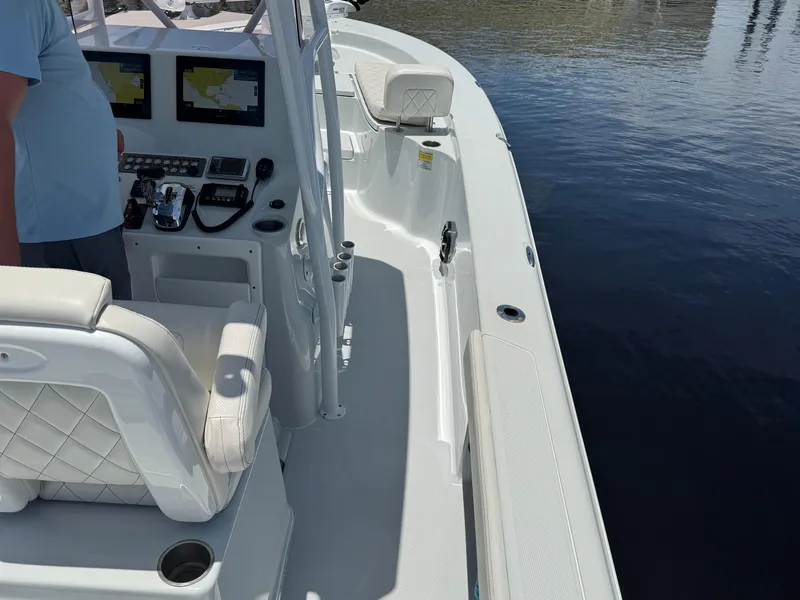 Slide: The Image of 2019 Blue Wave 2800 Pure Hybrid boat interior with navigation screens and seating. - 21