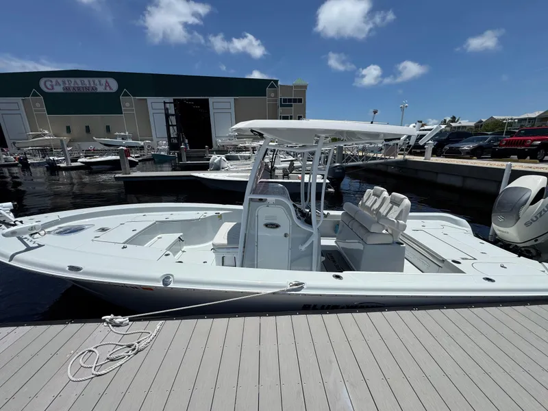 Slide: The Image of 2019 Blue Wave 2800 Pure Hybrid boat docked at marina under clear blue sky. - 3