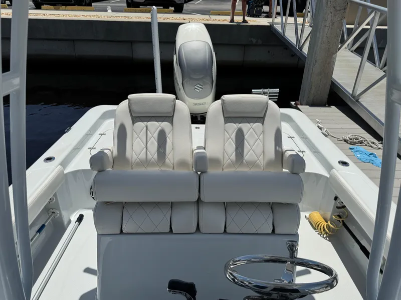 Slide: The Image of 2019 Blue Wave 2800 Pure Hybrid boat interior with dual seats and steering wheel. - 5