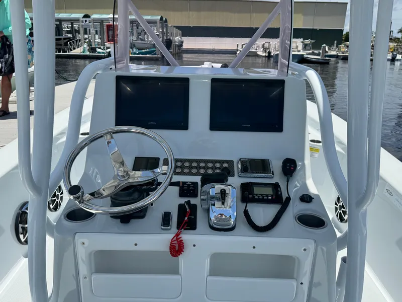 Slide: The Image of 2019 Blue Wave 2800 Pure Hybrid boat dashboard with steering wheel and electronic controls. - 6
