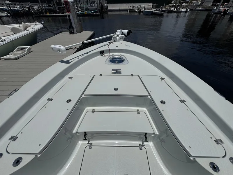 Slide: The Image of 2019 Blue Wave 2800 Pure Hybrid boat docked at marina, showcasing spacious deck layout. - 7