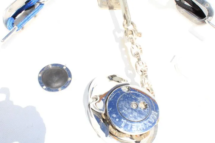 Slide: The Image of Anchor winch on 1989 Eagle Pilothouse boat deck with chain and blue rope. - 14