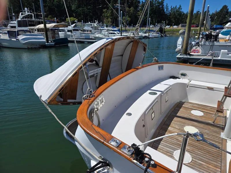 Slide: The Image of 1989 Eagle Pilothouse boat with open hatch, docked in a marina. - 15
