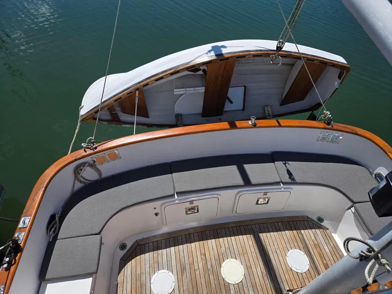 Slide: The Image of 1989 Eagle Pilothouse boat deck with wooden trim and cushioned seating. - 16