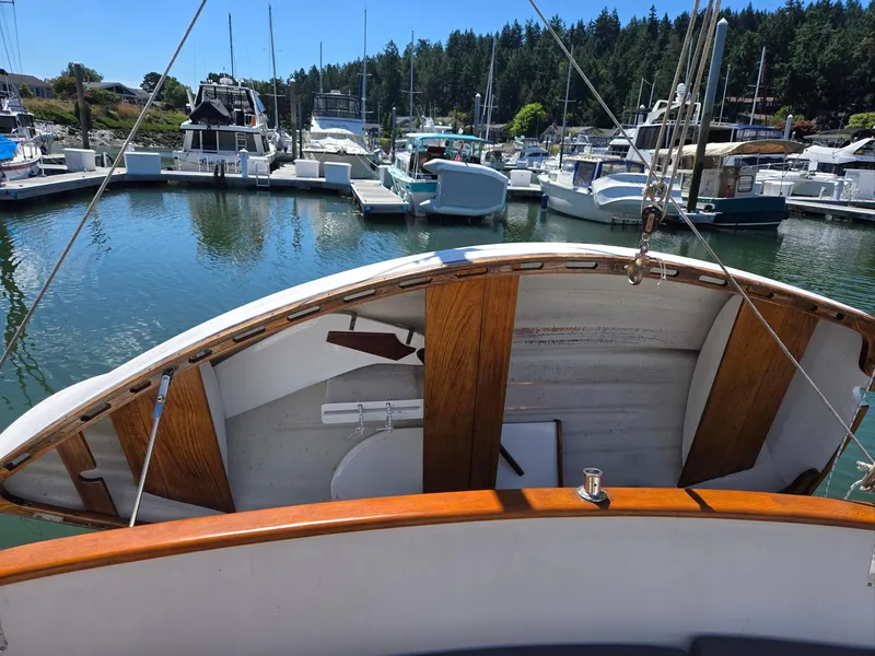 Slide: The Image of 1989 Eagle Pilothouse boat docked in a marina with surrounding yachts and trees. - 17