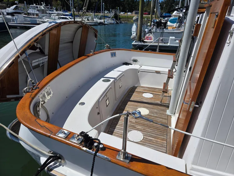 Slide: The Image of 1989 Eagle Pilothouse boat deck with wooden accents in a marina setting. - 18