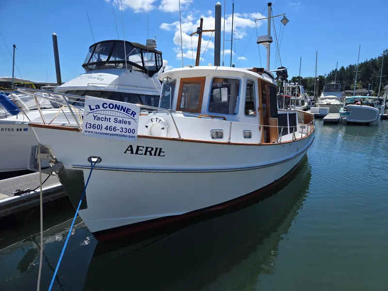 Slide: The Image of 1989 Eagle Pilothouse yacht docked, featuring "AERIE" name and La Conner Yacht Sales sign. - 2