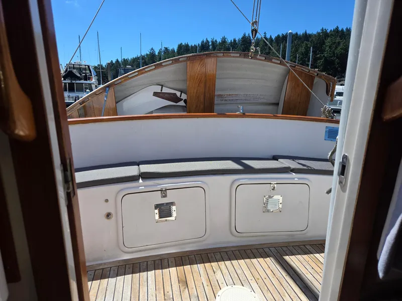 Slide: The Image of 1989 Eagle Pilothouse boat interior with wooden deck and cushioned seating. - 20