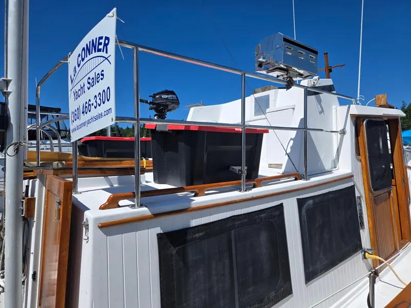 Slide: The Image of 1989 Eagle Pilothouse yacht with sales sign, featuring wooden accents and outdoor equipment. - 22