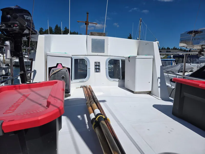 Slide: The Image of 1989 Eagle Pilothouse boat deck with storage bins and equipment under clear blue sky. - 23